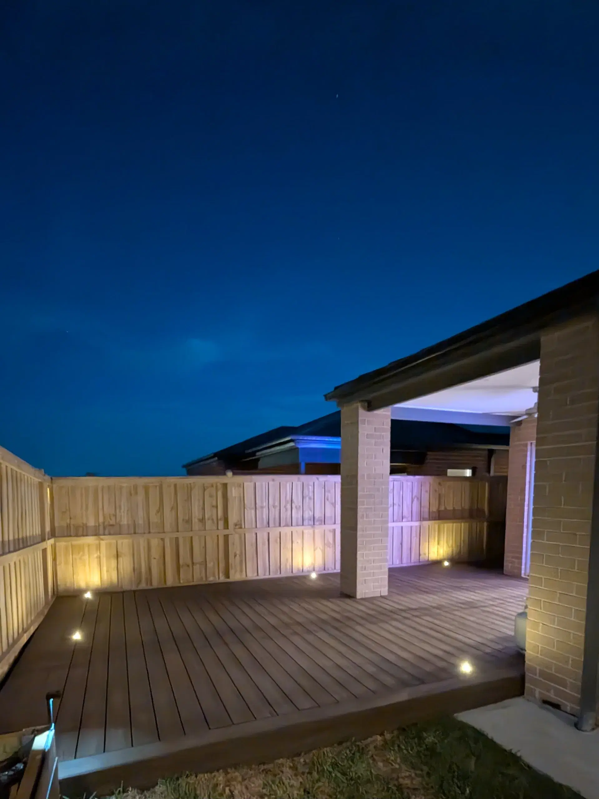 A CoreCraft-built raised timber deck with steps and planter boxes