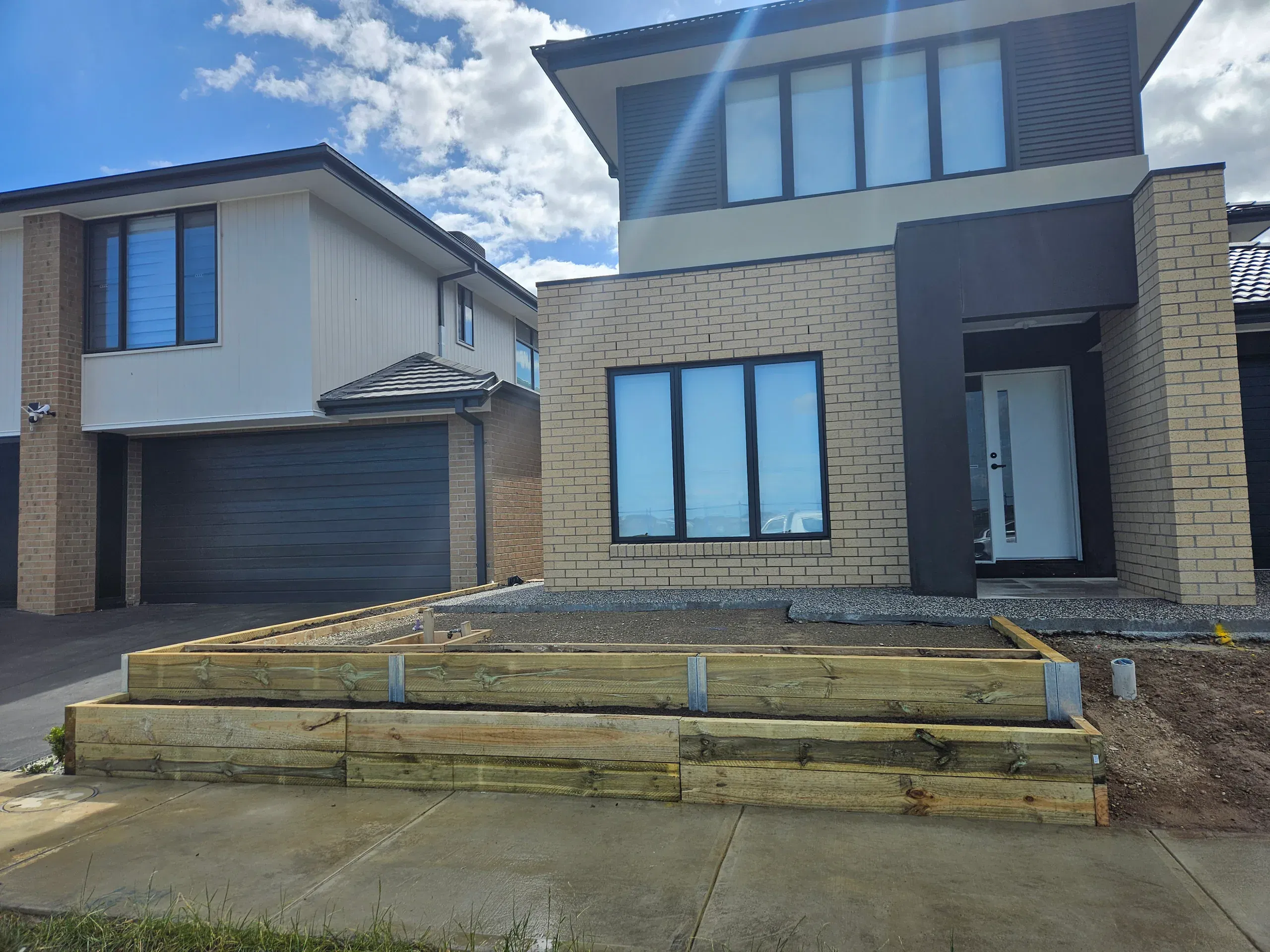 Clyde front-yard landscaping — retaining beds and turf