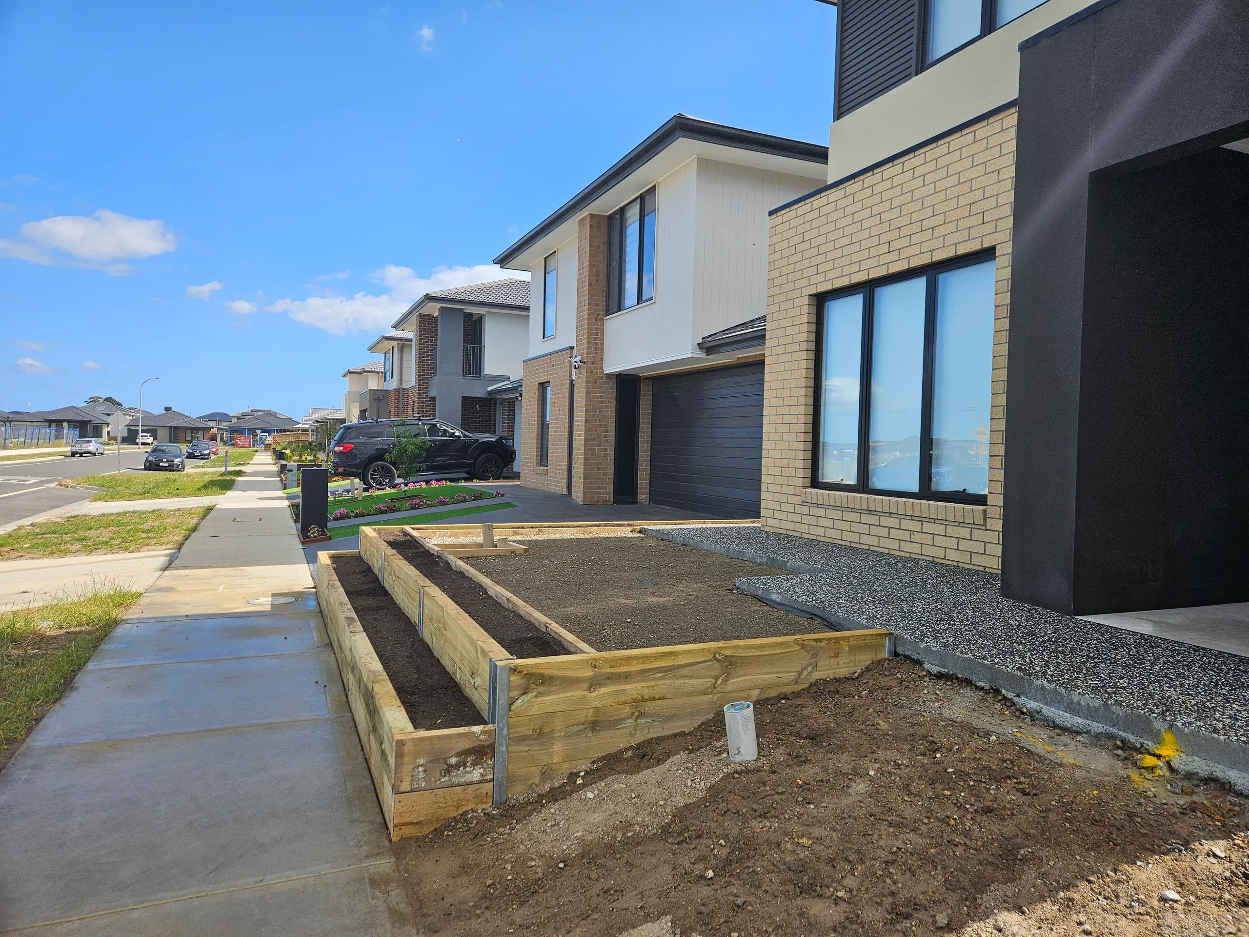 Clyde front-yard landscaping — retaining beds and turf