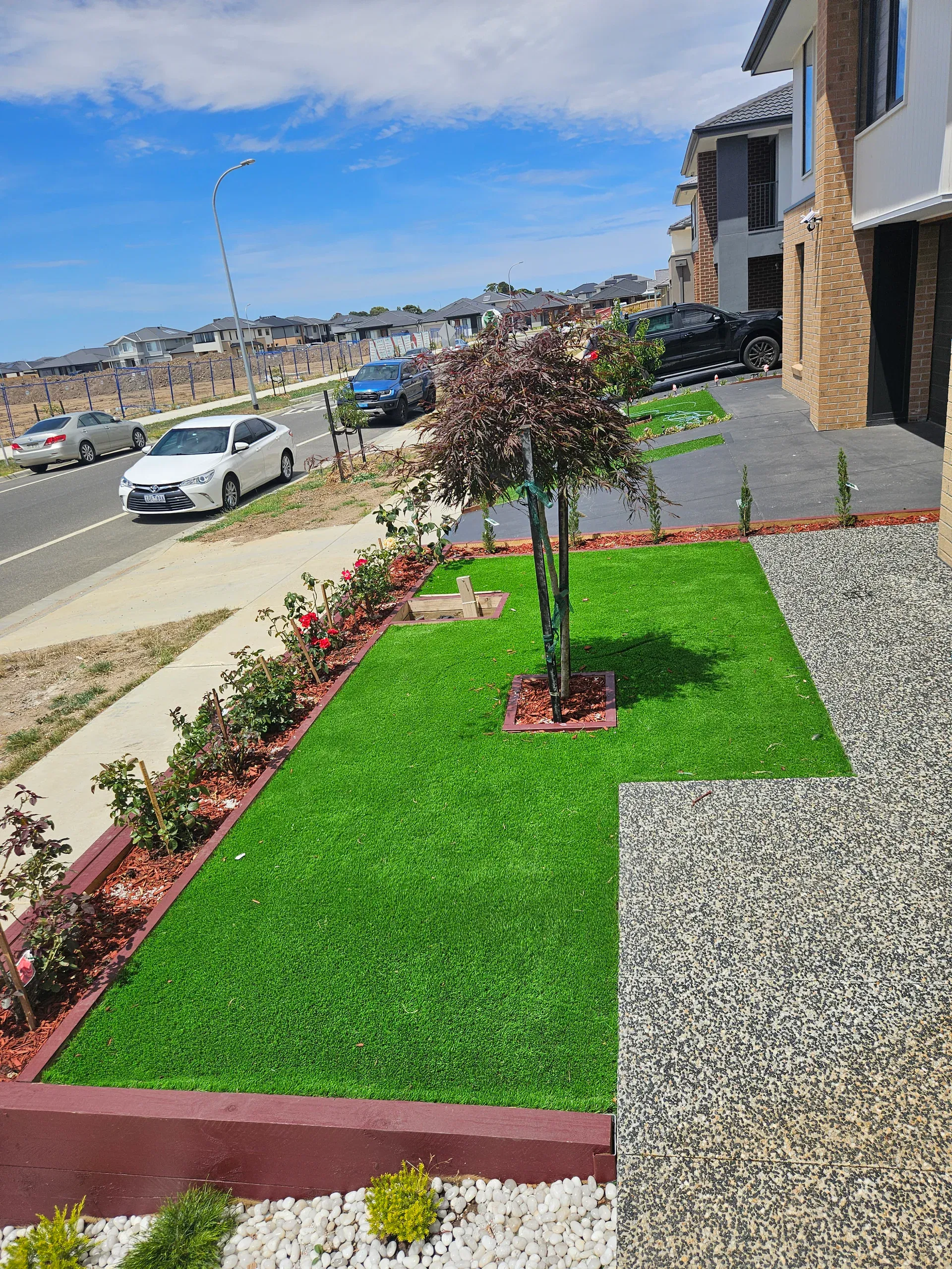 Clyde front-yard landscaping — retaining beds and turf