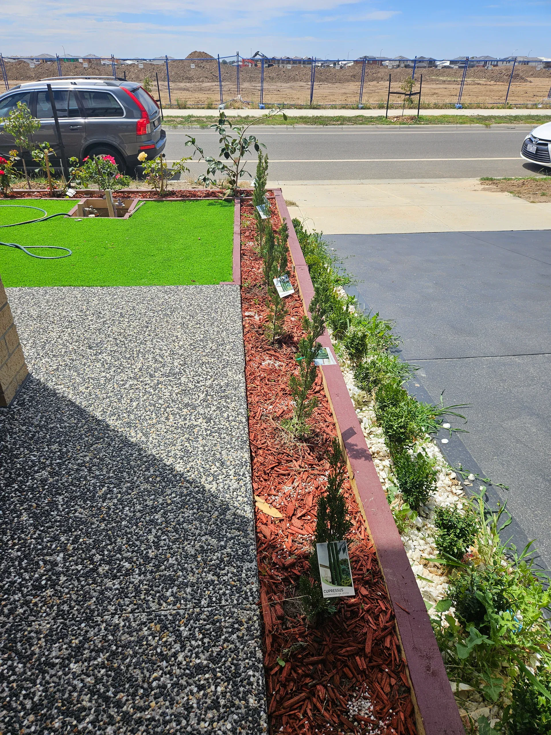 Clyde front-yard landscaping — retaining beds and turf