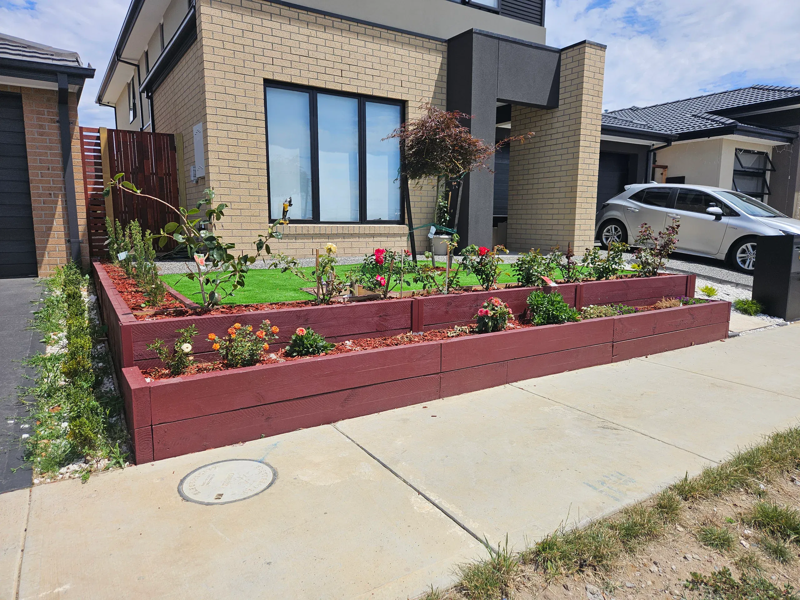 Clyde front-yard landscaping — retaining beds and turf