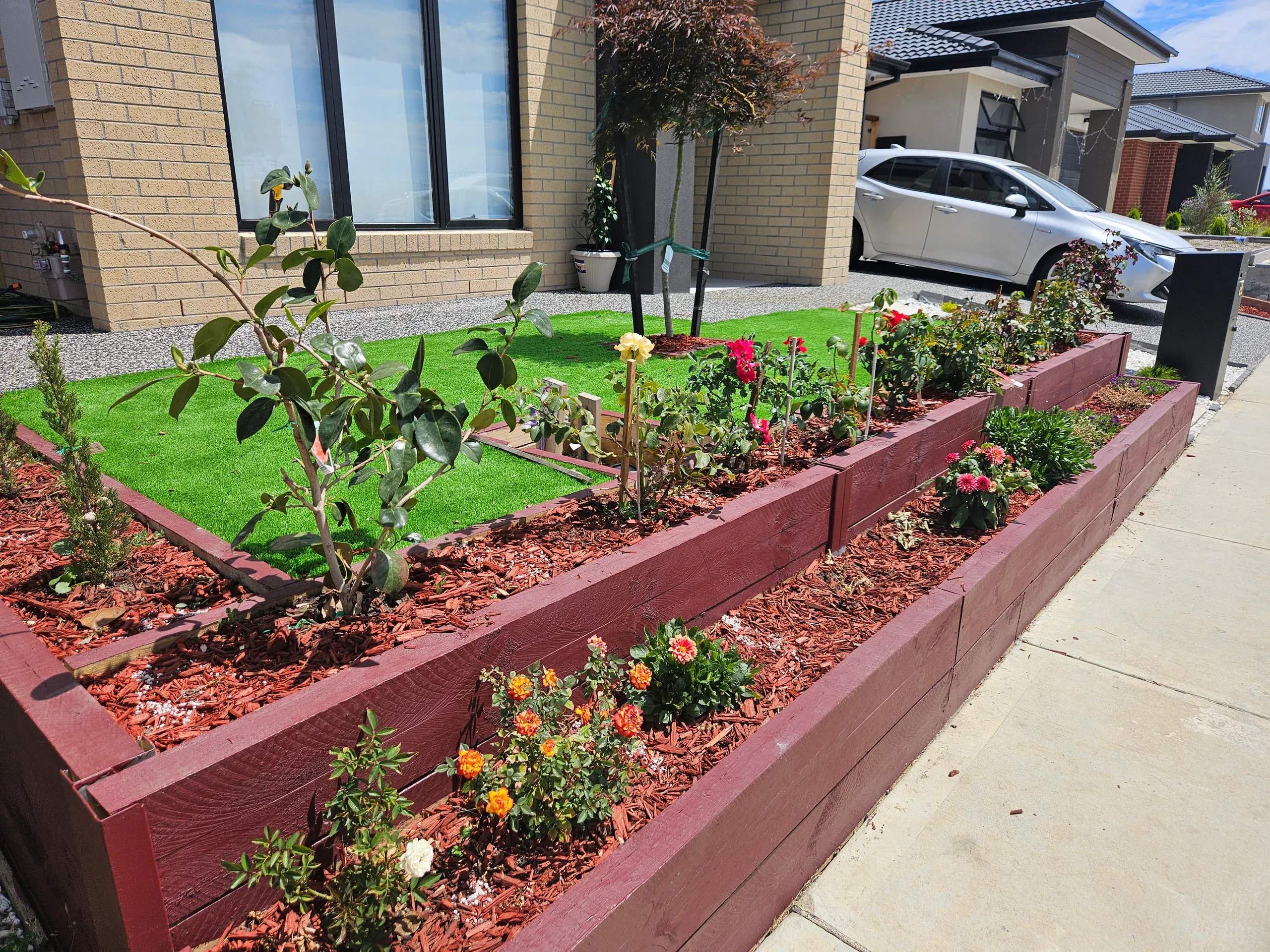 Clyde front-yard landscaping — retaining beds and turf
