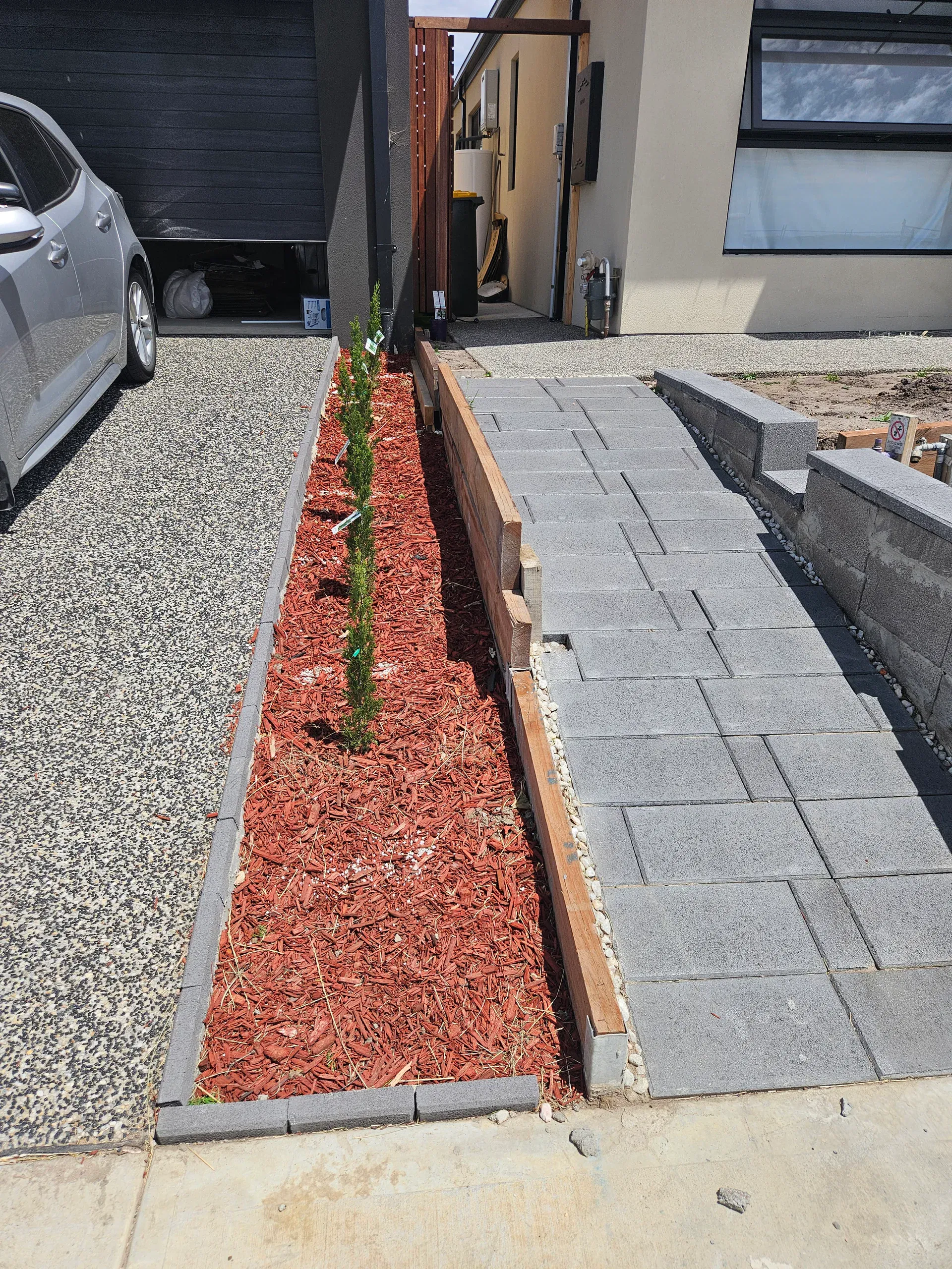 Clyde front-yard landscaping — retaining beds and turf