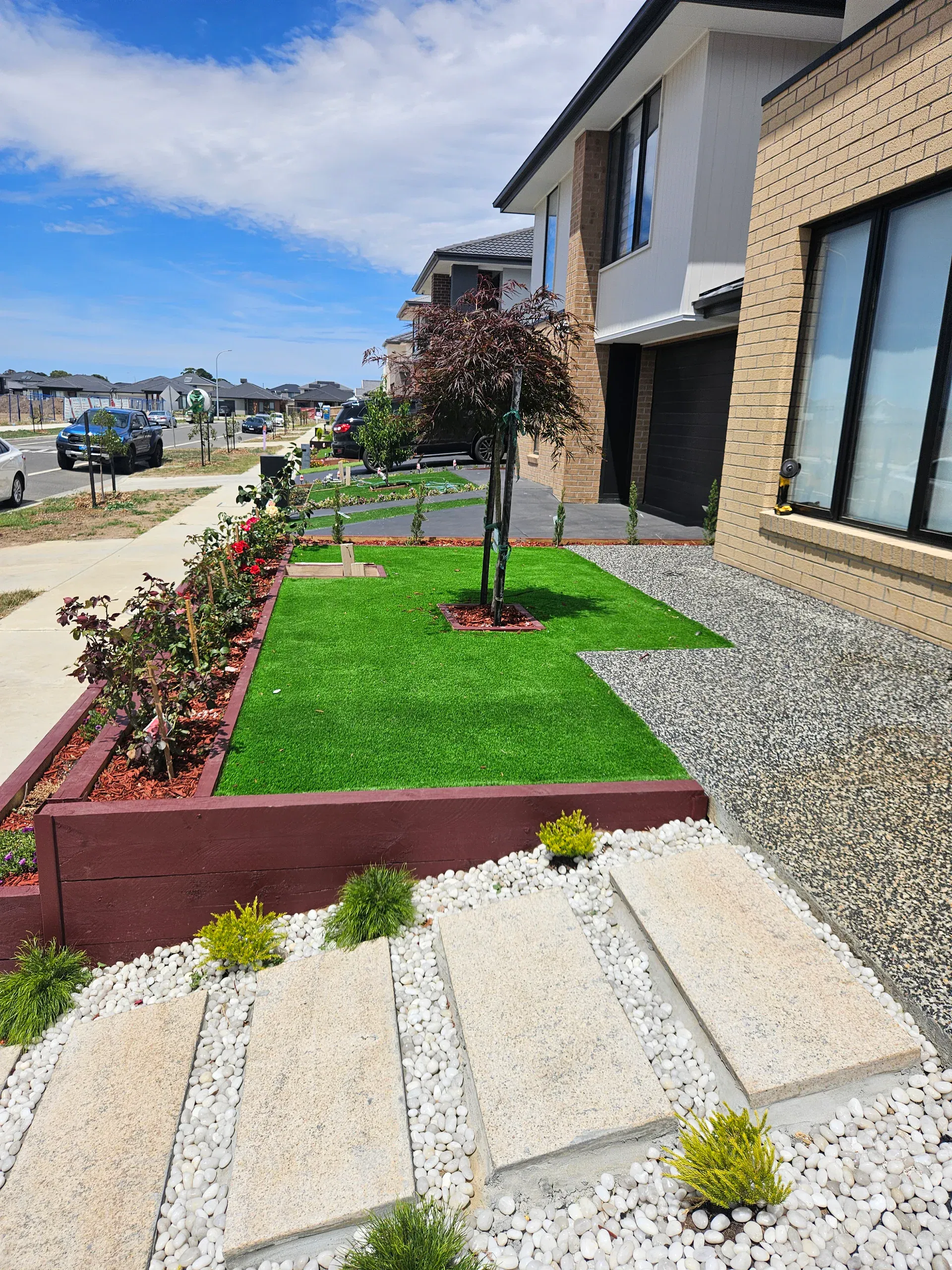 Clyde front-yard landscaping — retaining beds and turf