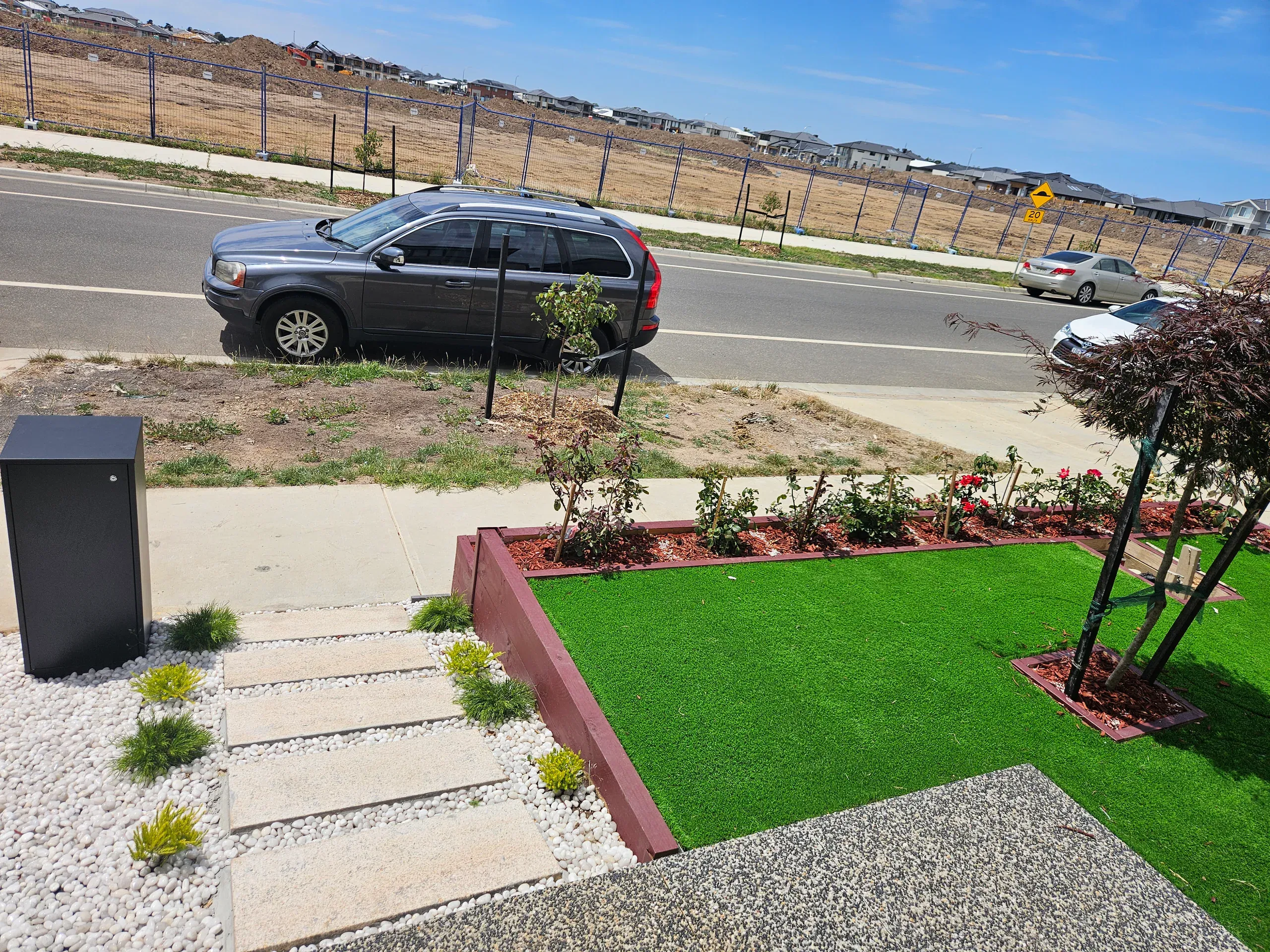 Clyde front-yard landscaping — retaining beds and turf