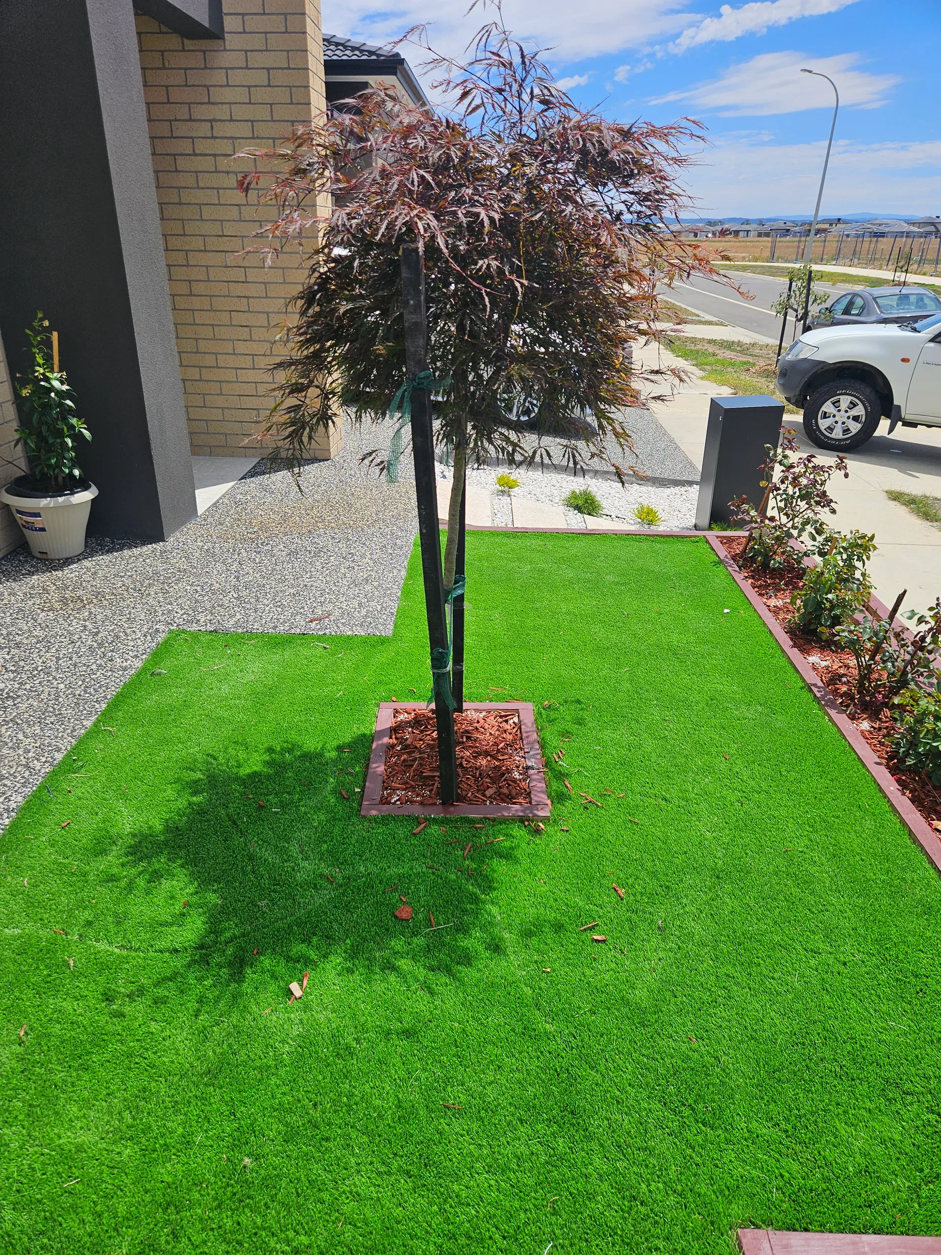 Clyde front-yard landscaping — retaining beds and turf