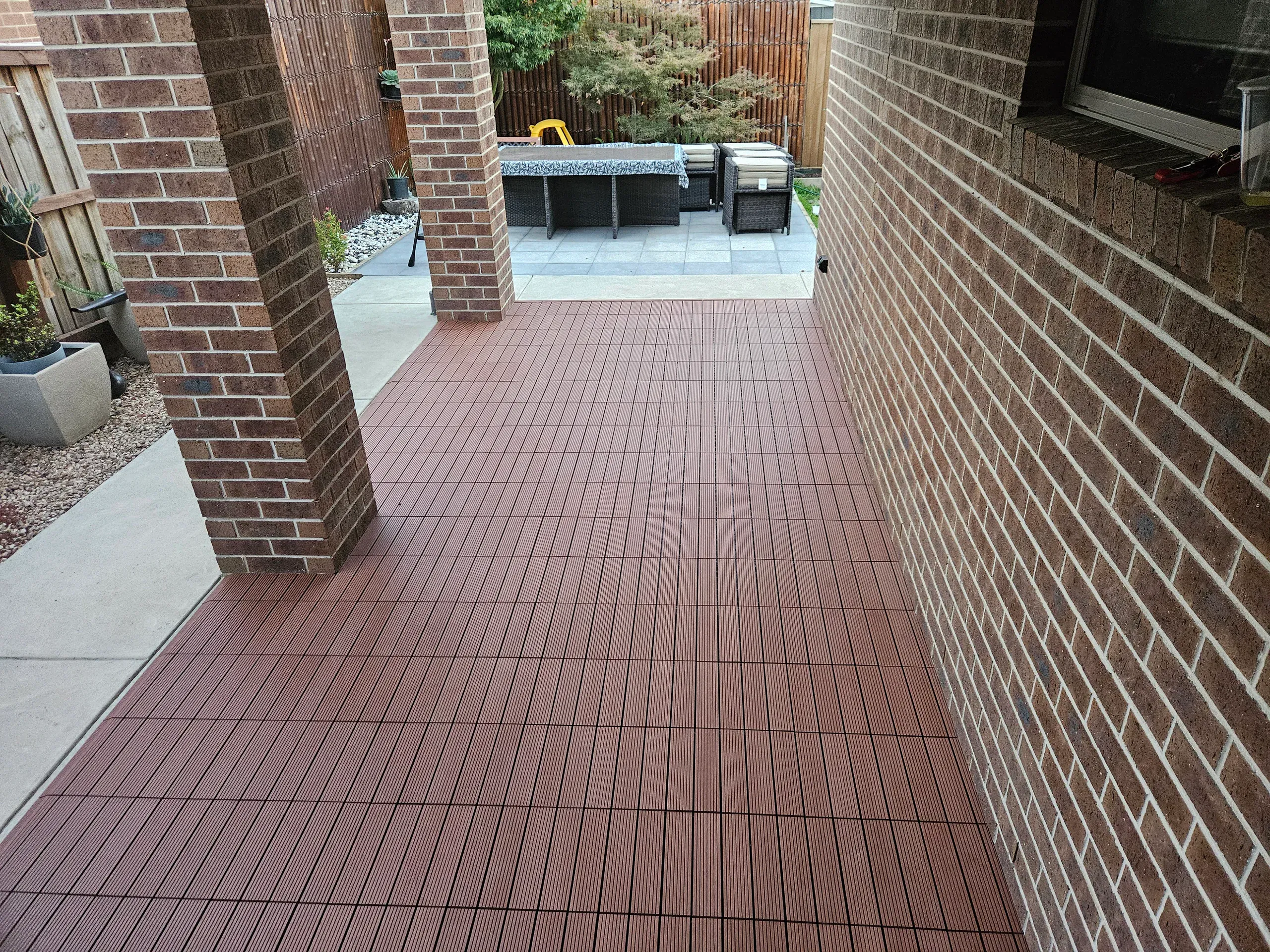 Composite deck tiles laid over concrete