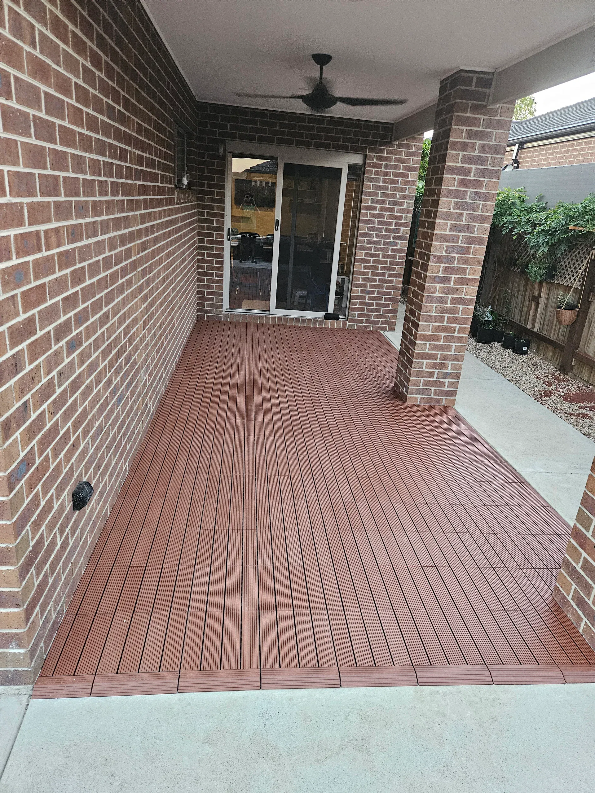 Composite deck tiles laid over concrete