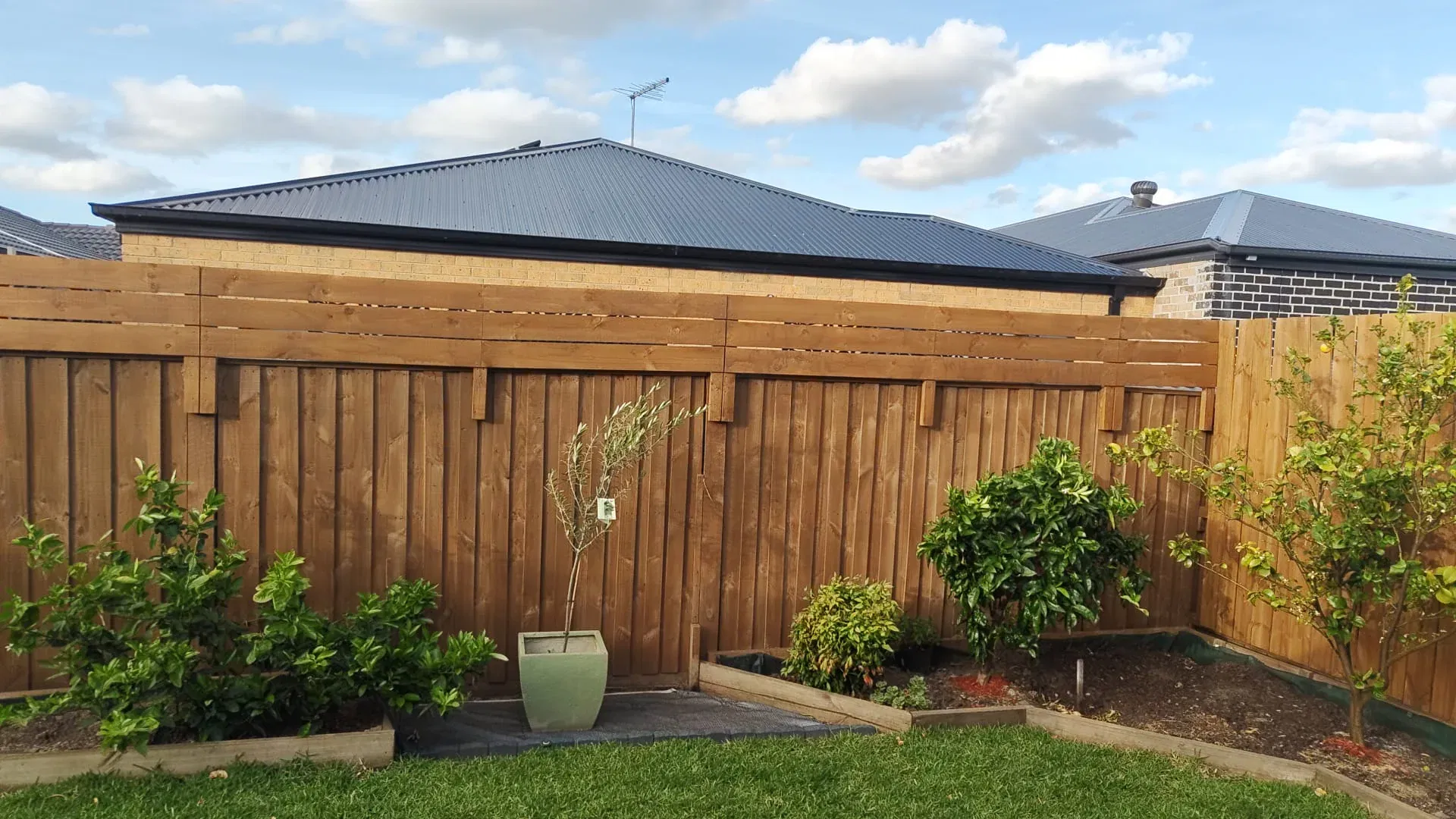Timber fence extension with decorative topper for added privacy