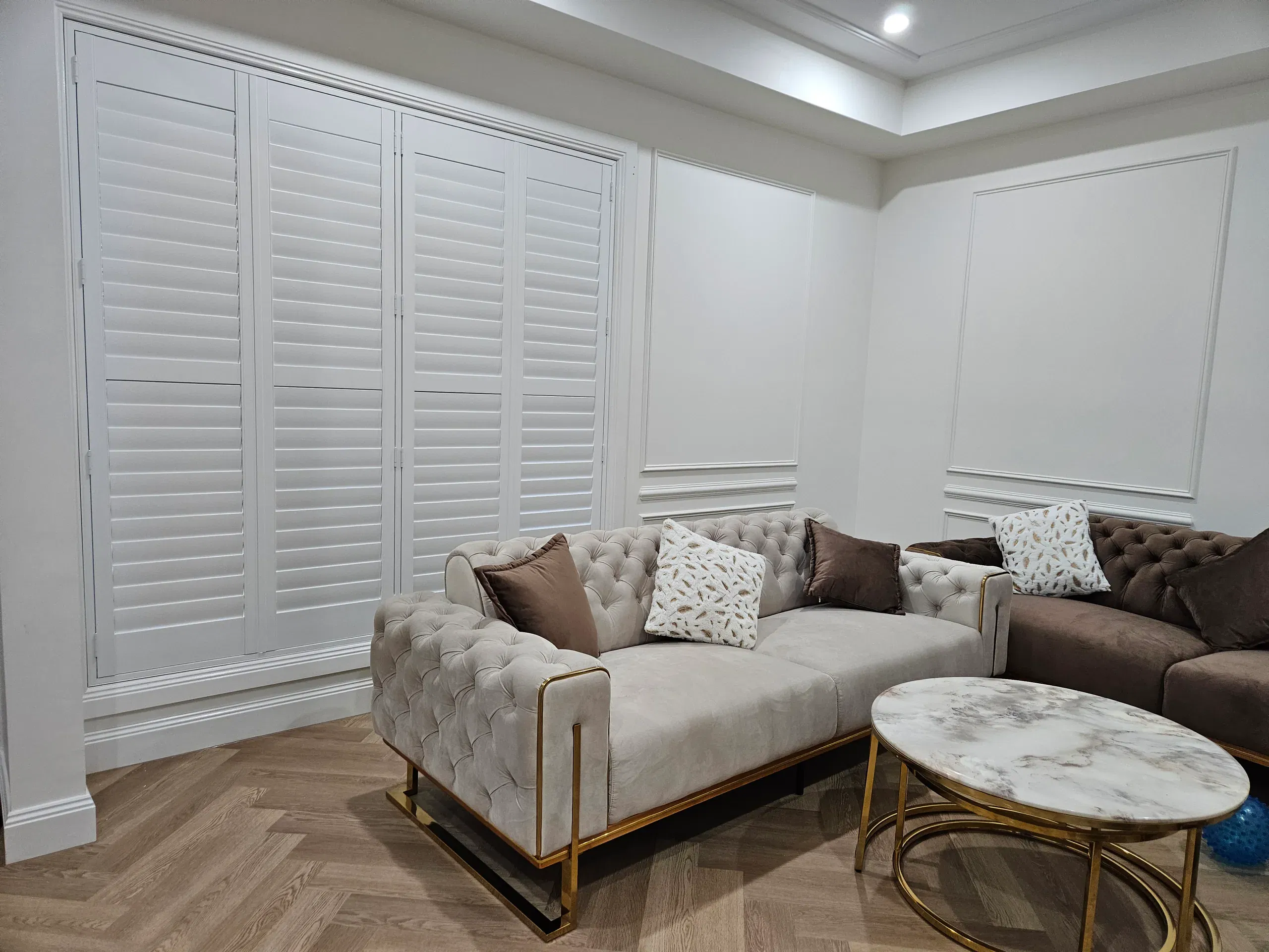 White plantation shutters on large living-room windows
