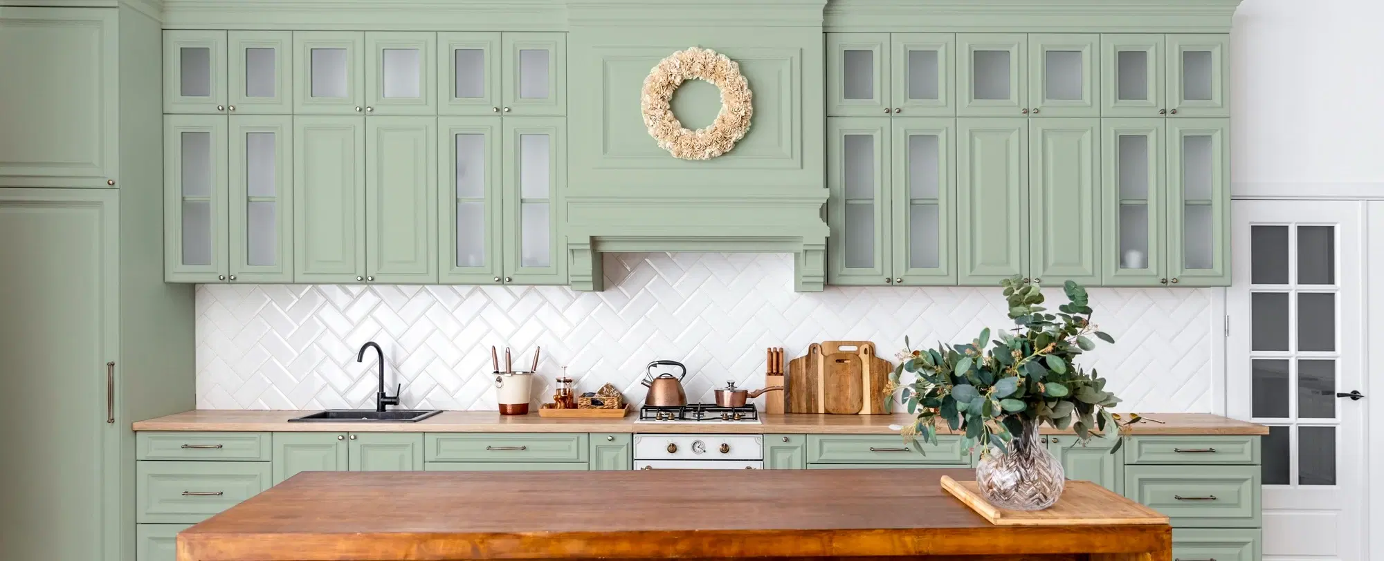A renovated kitchen with stone benchtops and full-height cabinetry