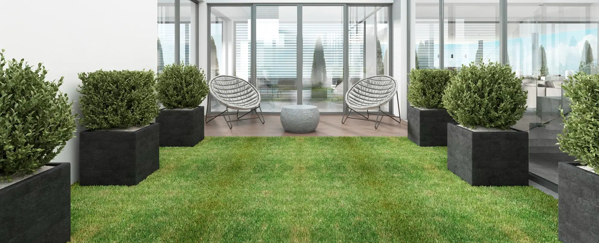 A landscaped backyard with retaining, lawn and garden beds